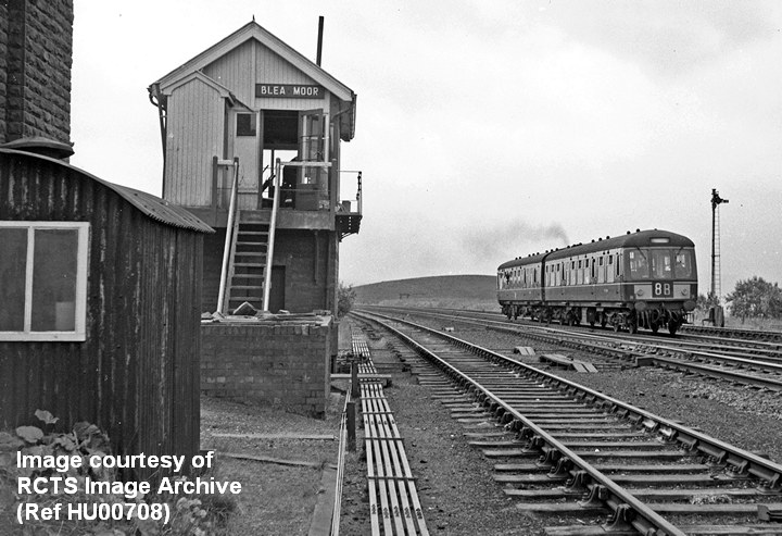 Blea Moor Signal Box from the north with a DMU passing on the 'Down' main line.