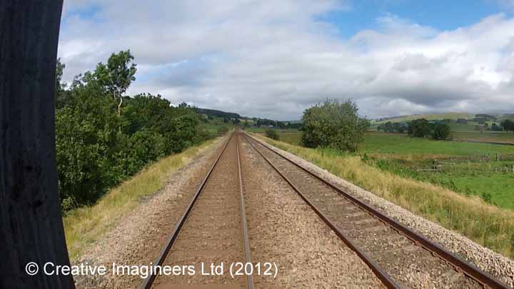 Cab-view image showing the site of Helwith Bridge Signal Box.
