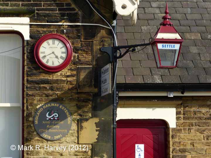 Settle Station: clock, bracket lamp and 125th anniversary plaque