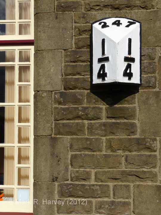 Ribblehead Station Booking Office: Detail view, milepost and window-frame