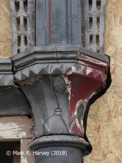 Glazed screen during restoration: 13 - Cracked capital collar and old paint layers.