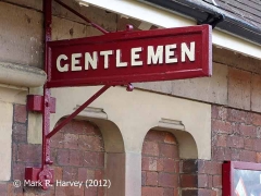 "Gentlemen" sign on wall of Appleby Station booking office building.