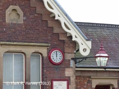 Appleby Station booking-office gable: trefoil, bargeboard, clock and bracket lantern.