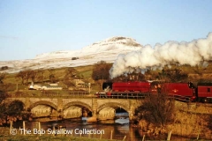 Steam loco 46203 crossing Ribble Viaduct, with snow-covered Pen-y-ghent beyond